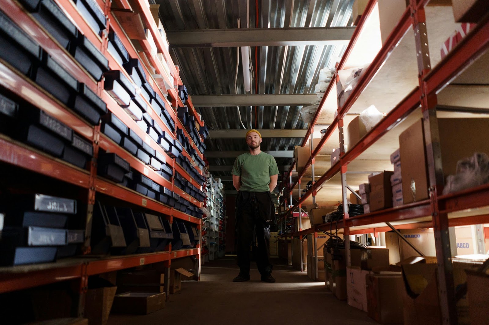 Man Standing in a Pile of Inventory Stocks