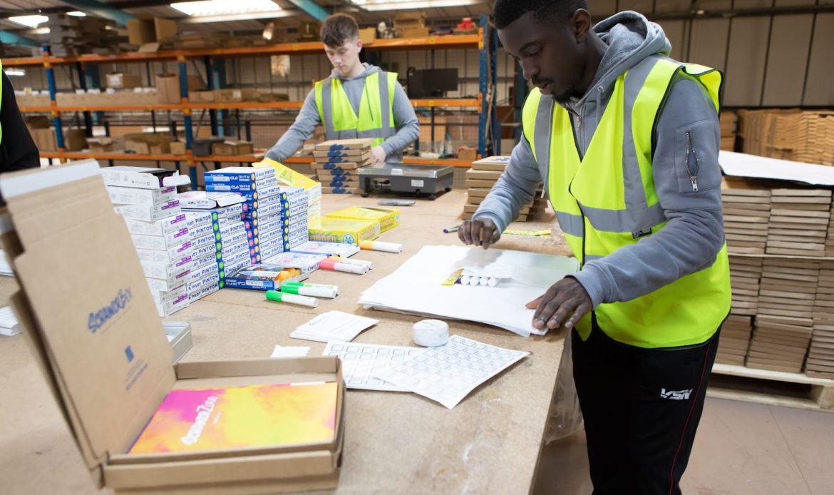 Two Men Busy Packing Goods